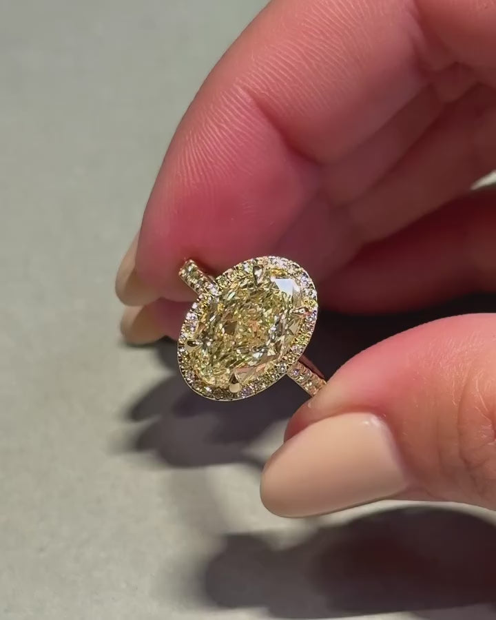 3 CT Fancy Yellow Oval Cut Lab Grown Diamond Halo Engagement Ring in 14K Yellow Gold.